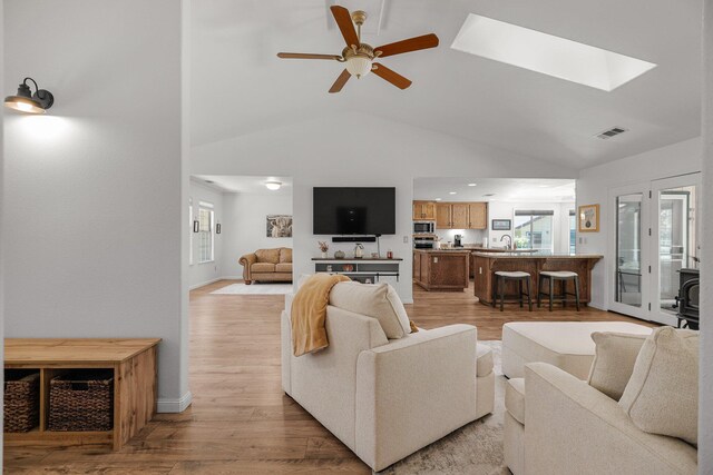21247 Creekside Dr, Red Bluff, CA 96080 - living room with ceiling fan, healthy amount of natural light, a skylight, light wood-type flooring, and high vaulted ceiling