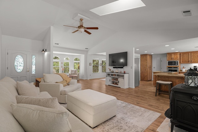 21247 Creekside Dr, Red Bluff, CA 96080 - living area featuring ceiling fan, a skylight, light wood finished floors, high vaulted ceiling, and recessed lighting