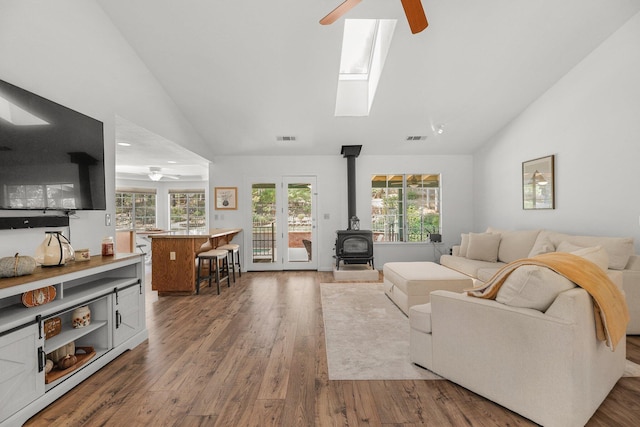 21247 Creekside Dr, Red Bluff, CA 96080 - living area with ceiling fan, a wood stove, wood finished floors, a skylight, and high vaulted ceiling