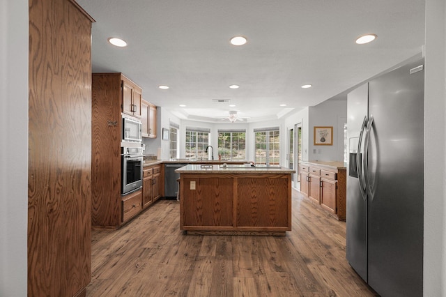 21247 Creekside Dr, Red Bluff, CA 96080 - kitchen with stainless steel appliances, dark wood finished floors, recessed lighting, a center island, and ceiling fan