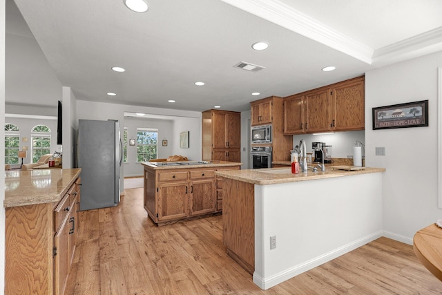 21247 Creekside Dr, Red Bluff, CA 96080 - kitchen with appliances with stainless steel finishes, a peninsula, light wood finished floors, and recessed lighting