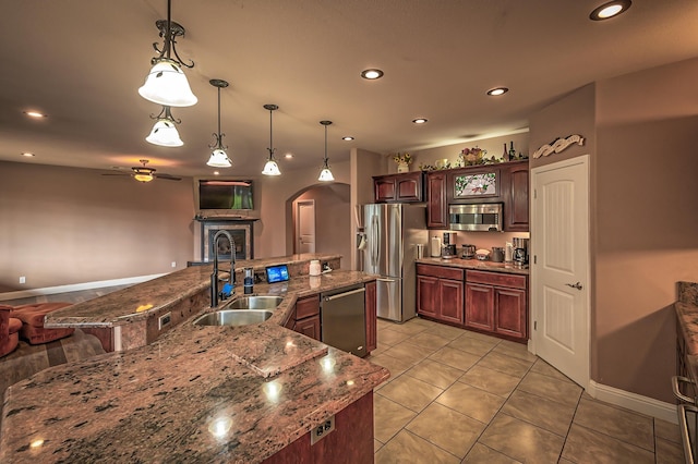 13787 Walter Ave, Redding, CA 96003 - kitchen with a sink, appliances with stainless steel finishes, arched walkways, ceiling fan, and pendant lighting