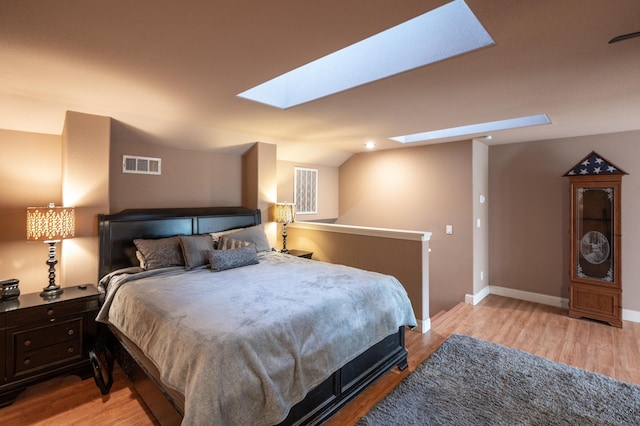 13787 Walter Ave, Redding, CA 96003 - bedroom featuring a skylight, wood finished floors, and baseboards