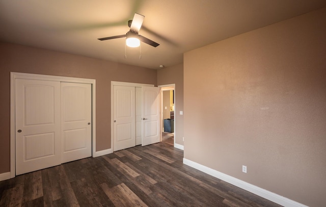 13787 Walter Ave, Redding, CA 96003 - unfurnished bedroom featuring two closets, baseboards, and dark wood-type flooring