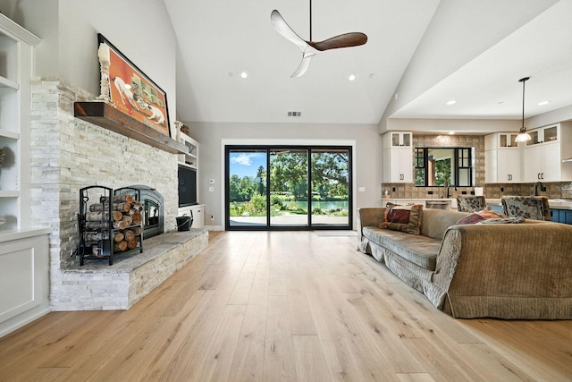 180 Agua Verdi Dr, Red Bluff, CA 96080 - living room with high vaulted ceiling, ceiling fan, light wood-type flooring, a fireplace, and recessed lighting