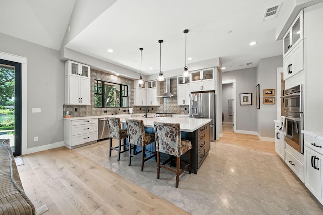 180 Agua Verdi Dr, Red Bluff, CA 96080 - kitchen featuring appliances with stainless steel finishes, wall chimney range hood, decorative backsplash, plenty of natural light, and recessed lighting