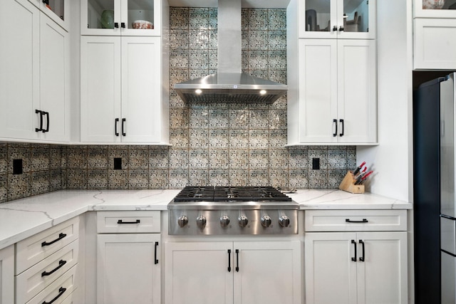 180 Agua Verdi Dr, Red Bluff, CA 96080 - kitchen with wall chimney range hood, freestanding refrigerator, stainless steel gas stovetop, and white cabinetry