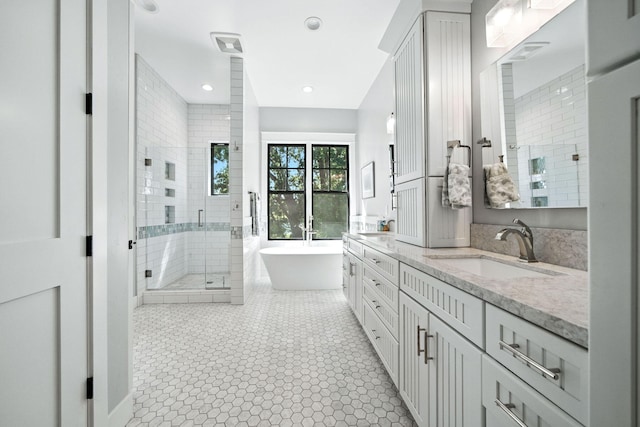 180 Agua Verdi Dr, Red Bluff, CA 96080 - bathroom with double vanity, a stall shower, a freestanding bath, tile patterned flooring, and recessed lighting