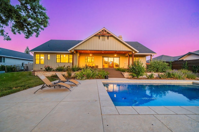 180 Agua Verdi Dr, Red Bluff, CA 96080 - back of house at dusk featuring board and batten siding, a patio, and a chimney