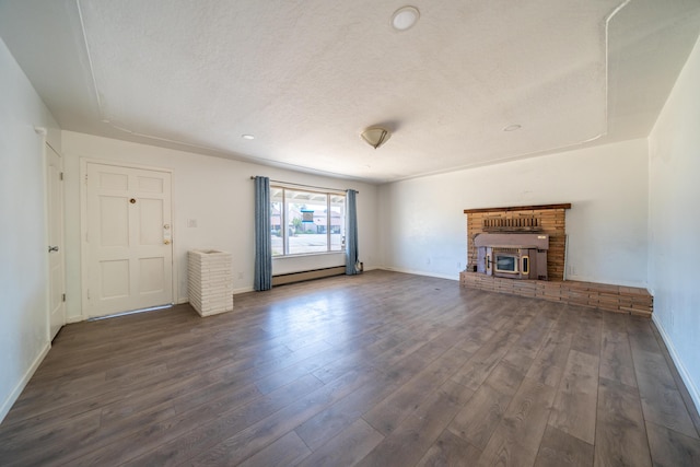 852 Lake Blvd, Redding, CA 96003 - unfurnished living room with baseboard heating, wood finished floors, a fireplace, baseboards, and a textured ceiling