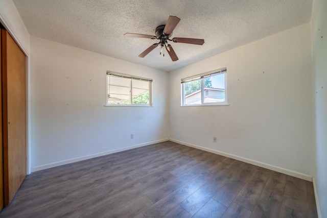 852 Lake Blvd, Redding, CA 96003 - spare room featuring a textured ceiling, dark wood-style floors, baseboards, and a ceiling fan