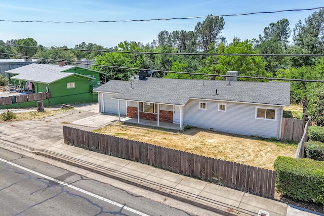 852 Lake Blvd, Redding, CA 96003 - ranch-style home featuring a fenced front yard, concrete driveway, covered porch, and brick siding