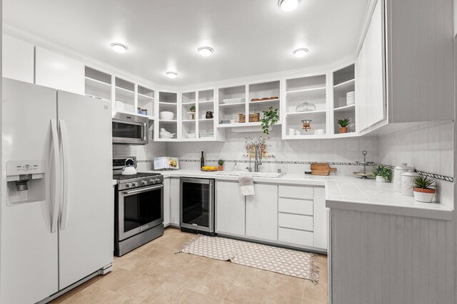 1545 Olive Ave, Redding, CA 96001 - kitchen with appliances with stainless steel finishes, beverage cooler, open shelves, white cabinetry, and tasteful backsplash