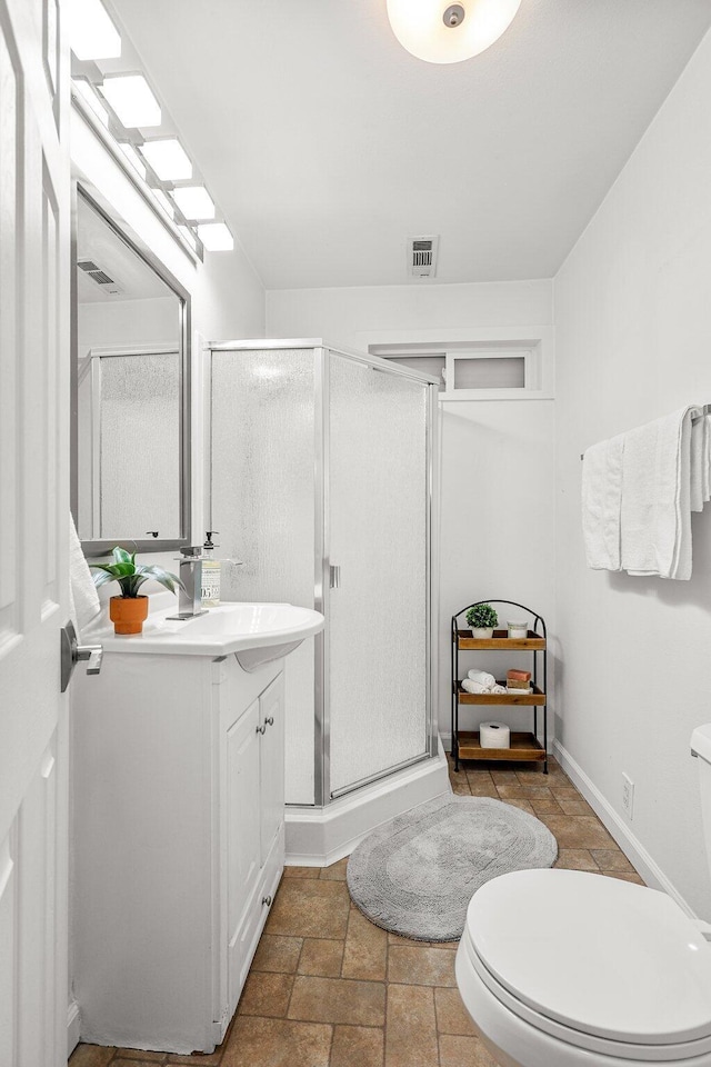 1545 Olive Ave, Redding, CA 96001 - bathroom with vanity, a shower stall, and stone tile flooring