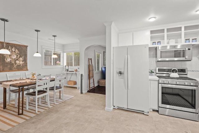 1545 Olive Ave, Redding, CA 96001 - kitchen with stainless steel appliances, white cabinets, ornamental molding, hanging light fixtures, and backsplash