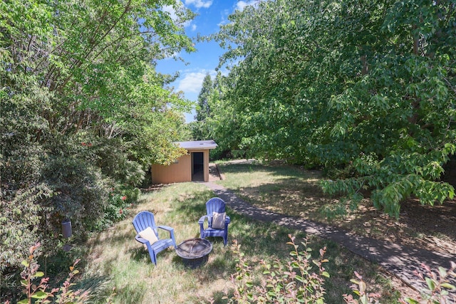 1545 Olive Ave, Redding, CA 96001 - view of yard featuring a fire pit and an outbuilding