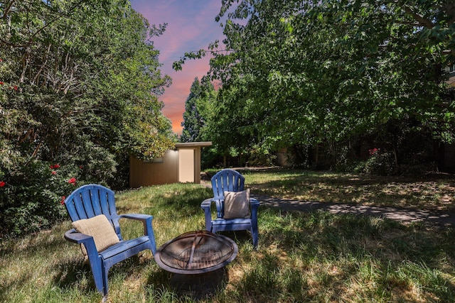1545 Olive Ave, Redding, CA 96001 - view of green lawn with a fire pit and an outbuilding