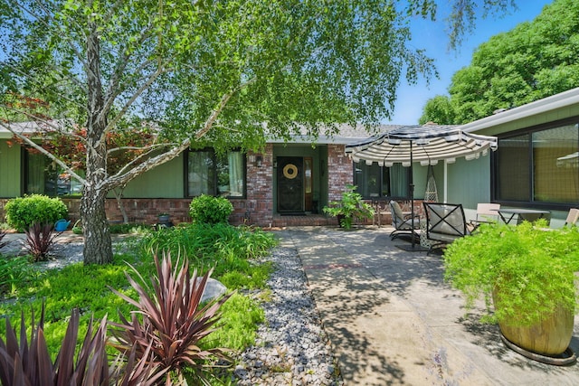 6966 Granada Dr, Redding, CA 96002 - view of front of house with a patio area, outdoor dining area, and brick siding