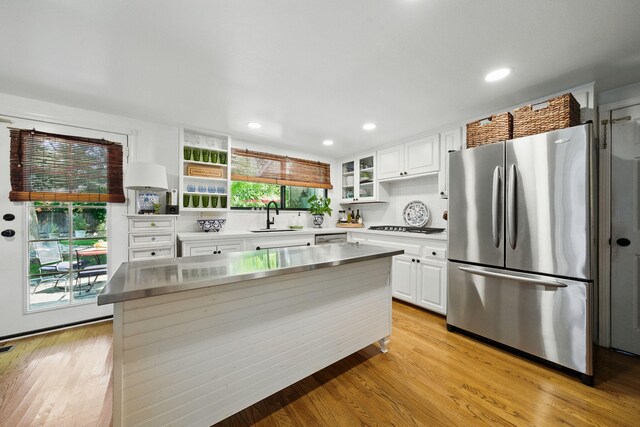 6966 Granada Dr, Redding, CA 96002 - kitchen featuring stainless steel appliances, a sink, white cabinetry, light wood-type flooring, and recessed lighting