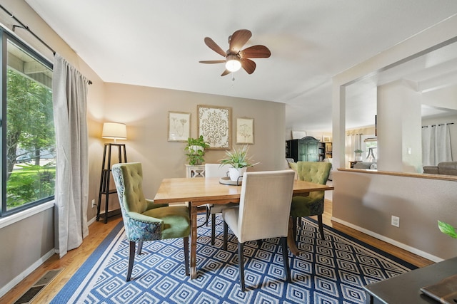6966 Granada Dr, Redding, CA 96002 - dining room with wood finished floors, healthy amount of natural light, a ceiling fan, and baseboards
