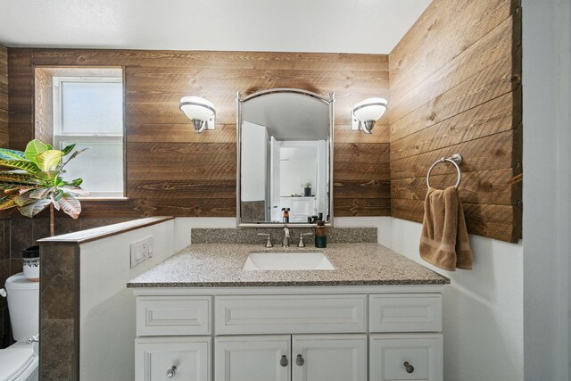 6966 Granada Dr, Redding, CA 96002 - bathroom with toilet, vanity, and wooden walls