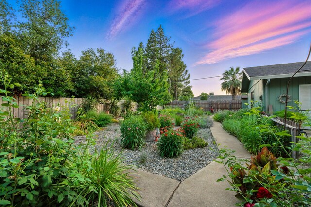 6966 Granada Dr, Redding, CA 96002 - yard at dusk featuring a fenced backyard