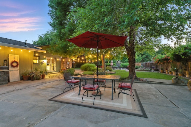 6966 Granada Dr, Redding, CA 96002 - patio terrace at dusk featuring a patio area, outdoor dining area, and french doors