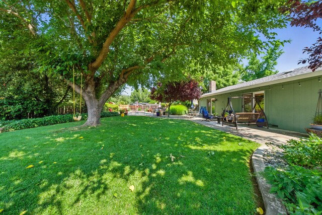 6966 Granada Dr, Redding, CA 96002 - view of green lawn with a patio