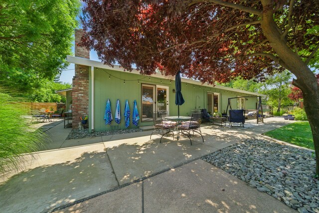 6966 Granada Dr, Redding, CA 96002 - rear view of property with a patio area and a chimney