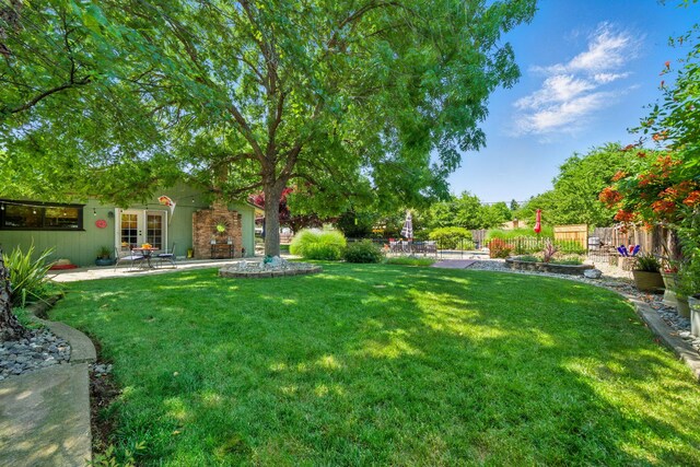 6966 Granada Dr, Redding, CA 96002 - view of yard featuring french doors and a patio area
