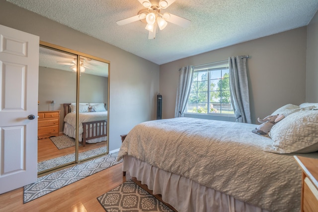 37255 Carson St, Burney, CA 96013 - bedroom with wood finished floors, a textured ceiling, a closet, and a ceiling fan