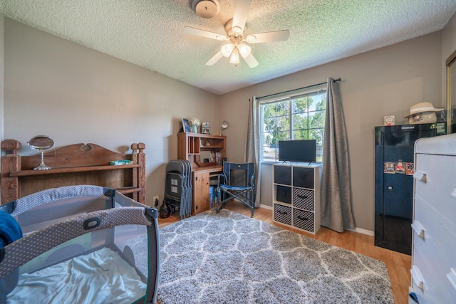 37255 Carson St, Burney, CA 96013 - bedroom featuring wood finished floors, a textured ceiling, a ceiling fan, and baseboards