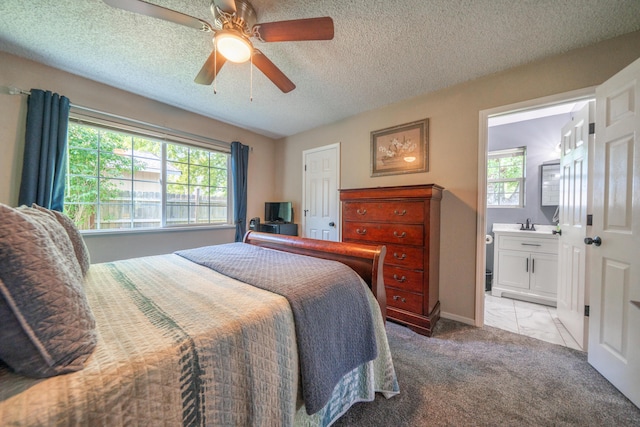 37255 Carson St, Burney, CA 96013 - carpeted bedroom featuring multiple windows, a textured ceiling, connected bathroom, ceiling fan, and baseboards