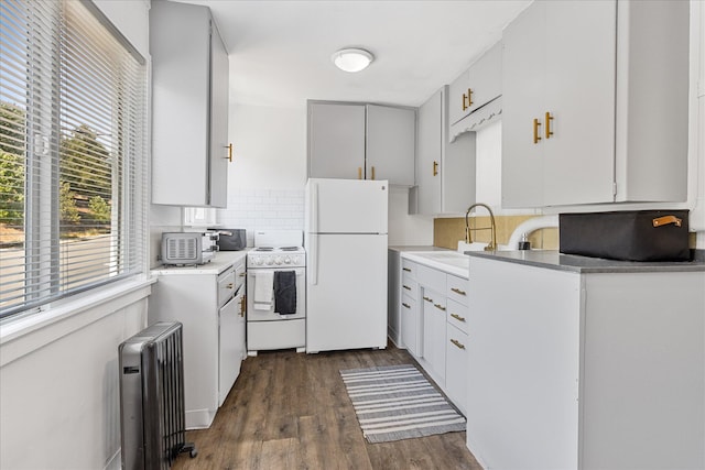 2005 E St, Redding, CA 96001 - kitchen featuring white appliances, radiator, tasteful backsplash, dark wood-type flooring, and light countertops