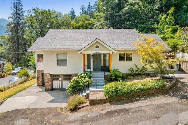 4400 Allen St, Dunsmuir, CA 96025 - view of front of property featuring stone siding, an attached garage, asphalt driveway, and roof with shingles