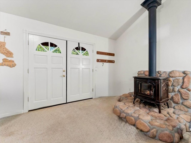 30821 Bambi Dr, Shingletown, CA 96088 - carpeted entryway featuring a wood stove and vaulted ceiling