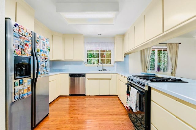 30821 Bambi Dr, Shingletown, CA 96088 - kitchen featuring stainless steel appliances, light countertops, light wood-style flooring, and cream cabinetry