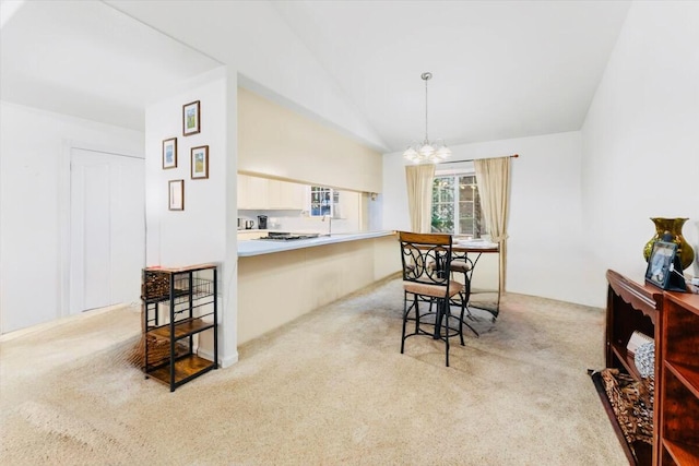 30821 Bambi Dr, Shingletown, CA 96088 - dining area featuring light carpet, a chandelier, and lofted ceiling