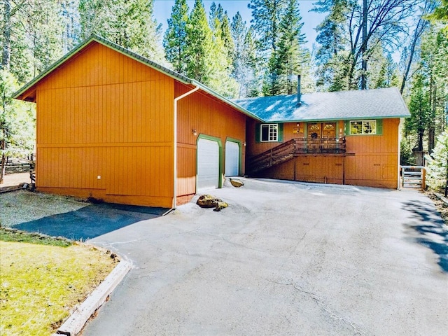 30821 Bambi Dr, Shingletown, CA 96088 - view of front of house with driveway, an attached garage, and covered porch