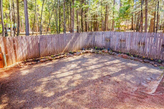 30821 Bambi Dr, Shingletown, CA 96088 - fenced backyard featuring a wooded view