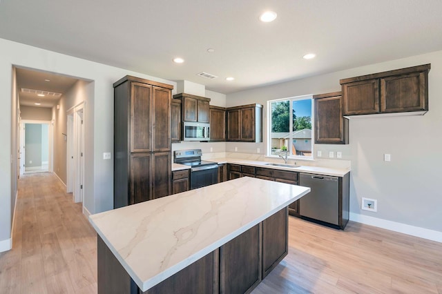 3707 Bloomsbury Ave, Shasta Lake, CA 96019 - kitchen featuring stainless steel appliances, light stone counters, light wood finished floors, dark brown cabinetry, and recessed lighting