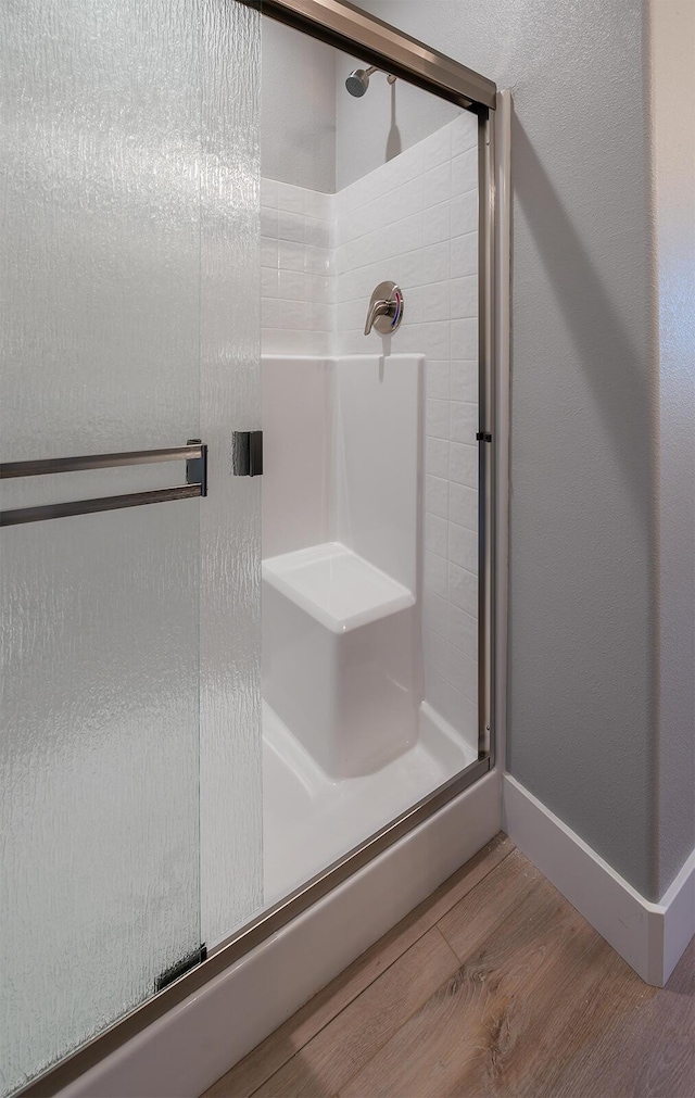 3707 Bloomsbury Ave, Shasta Lake, CA 96019 - bathroom with a stall shower and wood finished floors