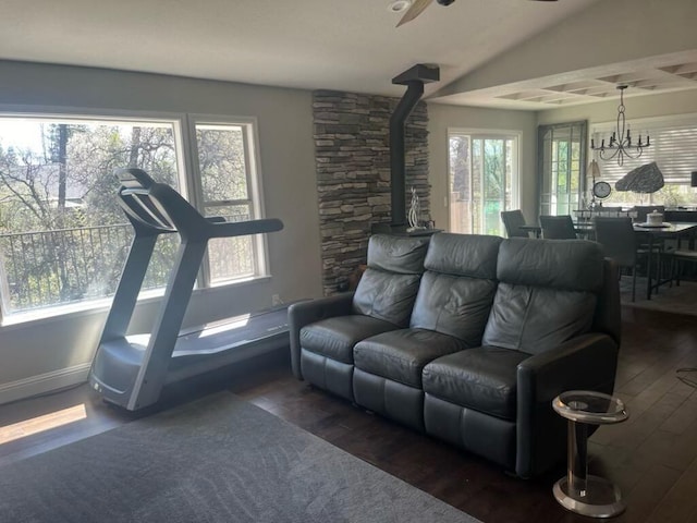 3837 Appalachian Way, Redding, CA 96001 - living room with wood finished floors, a wood stove, ceiling fan, baseboards, and a chandelier
