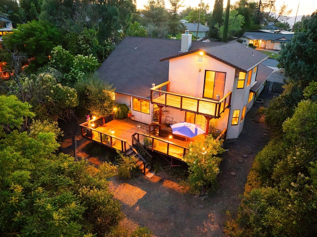 2173 Oak Ridge Dr, Redding, CA 96001 - back of property with a chimney, stucco siding, and a wooden deck