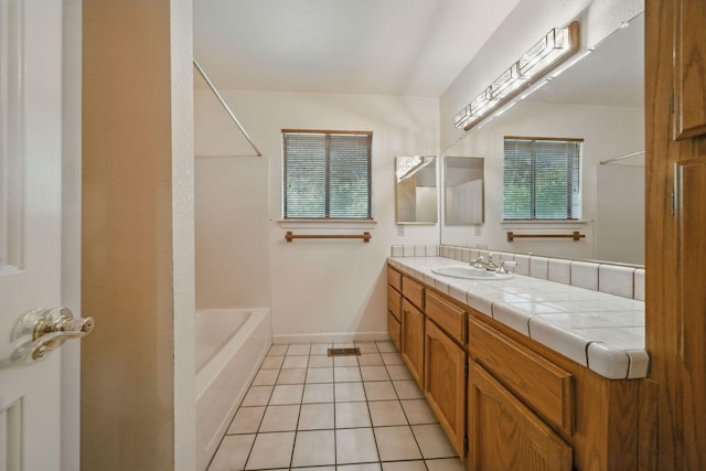 2173 Oak Ridge Dr, Redding, CA 96001 - bathroom featuring healthy amount of natural light, vanity, tile patterned flooring, and bathing tub / shower combination