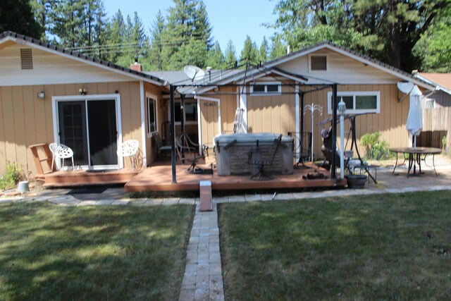 37023 Park Ave, Burney, CA 96013 - back of house with a hot tub, a wooden deck, and a lawn
