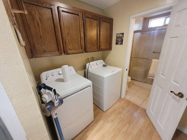 37023 Park Ave, Burney, CA 96013 - laundry room featuring separate washer and dryer, light wood-type flooring, and cabinet space