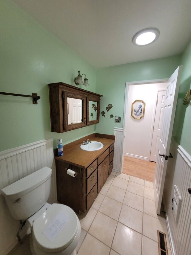 37023 Park Ave, Burney, CA 96013 - half bath featuring tile patterned floors, vanity, and wainscoting