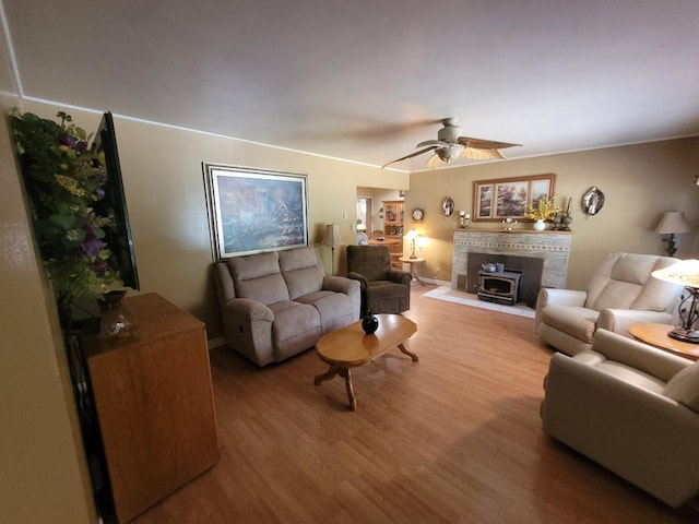 37023 Park Ave, Burney, CA 96013 - living room with wood finished floors, a wood stove, and ceiling fan