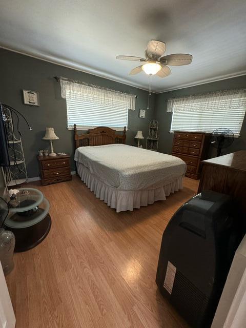37023 Park Ave, Burney, CA 96013 - bedroom with wood finished floors, ornamental molding, and ceiling fan
